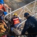 U.S. Coast Guardsmen attach brow to USCGC Calhoun