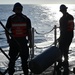 U.S. Coast Guardsmen transport fender aboard USCGC Calhoun