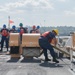 U.S. Coast Guardsmen attach tugboat to USCGC Calhoun