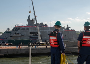 U.S. Coast Guardsmen prepare to moor USCGC Calhoun
