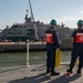 U.S. Coast Guardsmen prepare to moor USCGC Calhoun