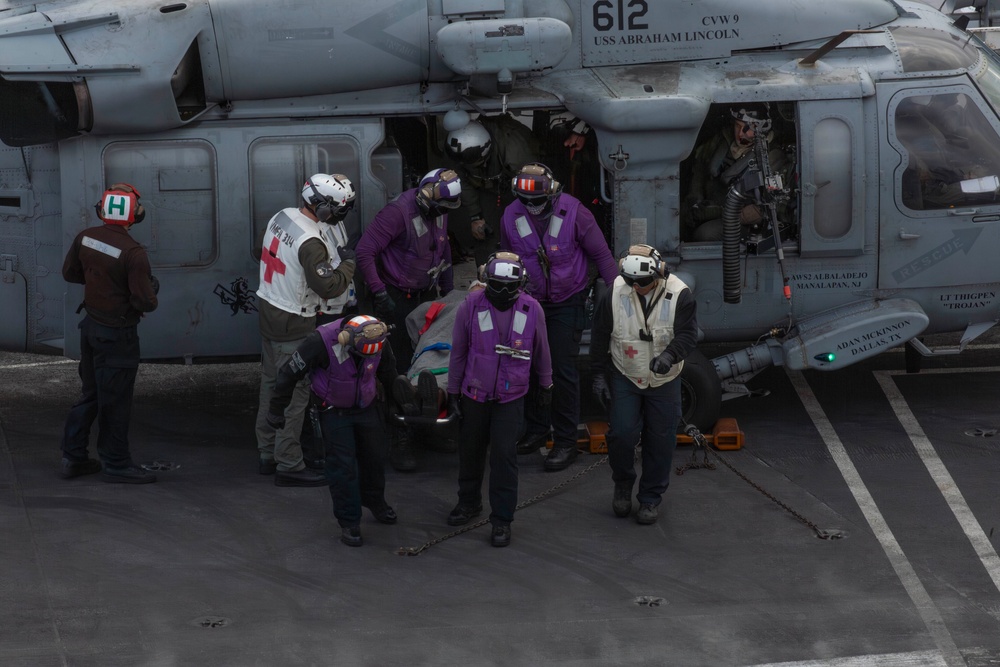 Sailors participate in a medical emergency drill aboard Abraham Lincoln