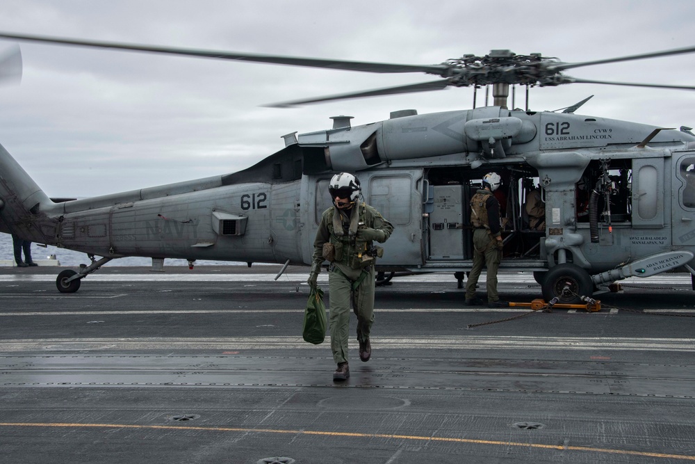 Capt. Pete Riebe participates in helicopter operations aboard Abraham Lincoln