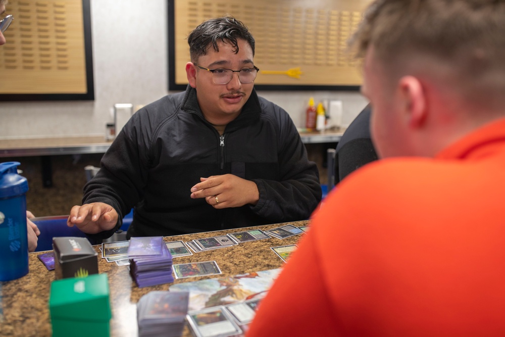 USS Tripoli Sailors play cards