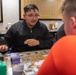 USS Tripoli Sailors play cards