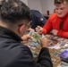 USS Tripoli Sailors play cards