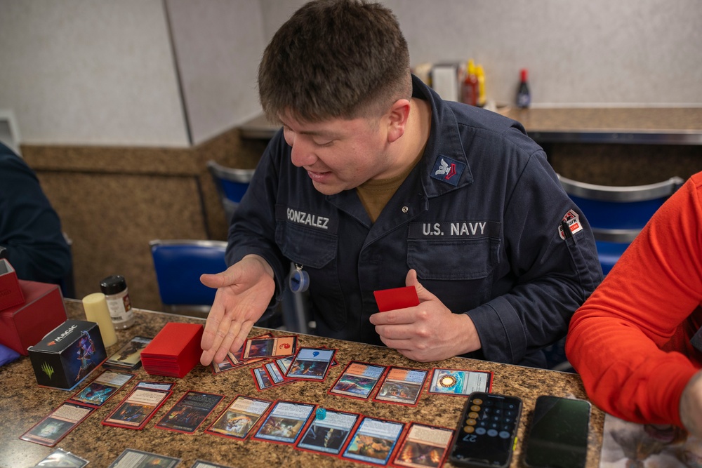 USS Tripoli Sailors play cards