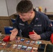 USS Tripoli Sailors play cards