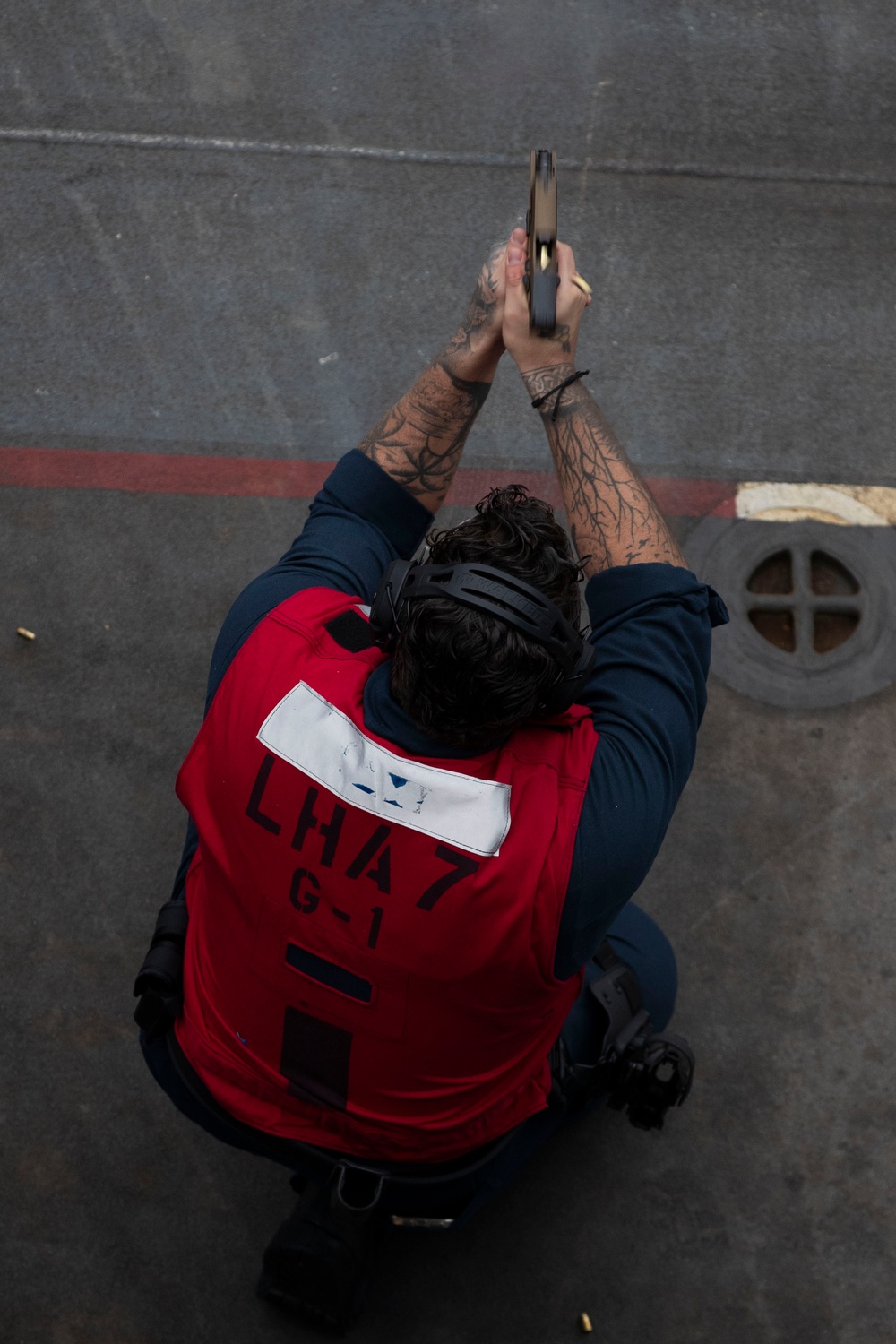 USS Tripoli Sailors practice with the M18 pistol