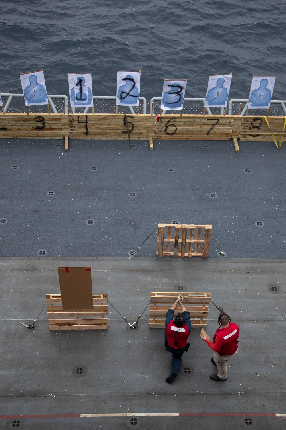 USS Tripoli Sailors practice with the M18 pistol