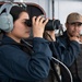 USS Tripoli Sailors stand aft lookout watch