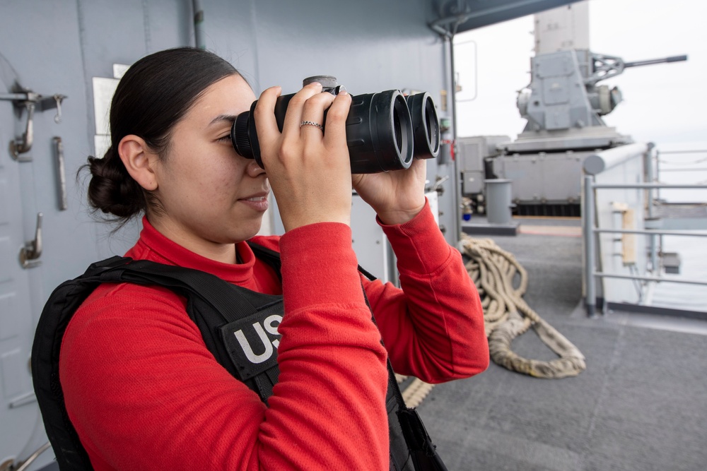 USS Tripoli Sailors stand aft lookout watch