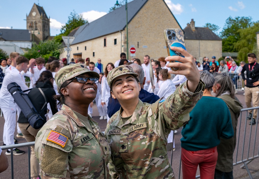 Soldiers Witness Olympic Torch in Sainte-Mere-Eglise