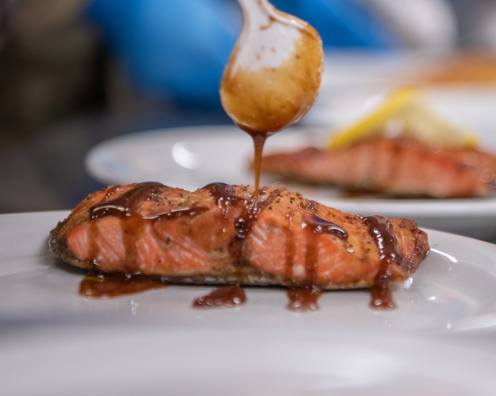 138th Fighter Wing services prepares a meal for the Air National Guard command chief