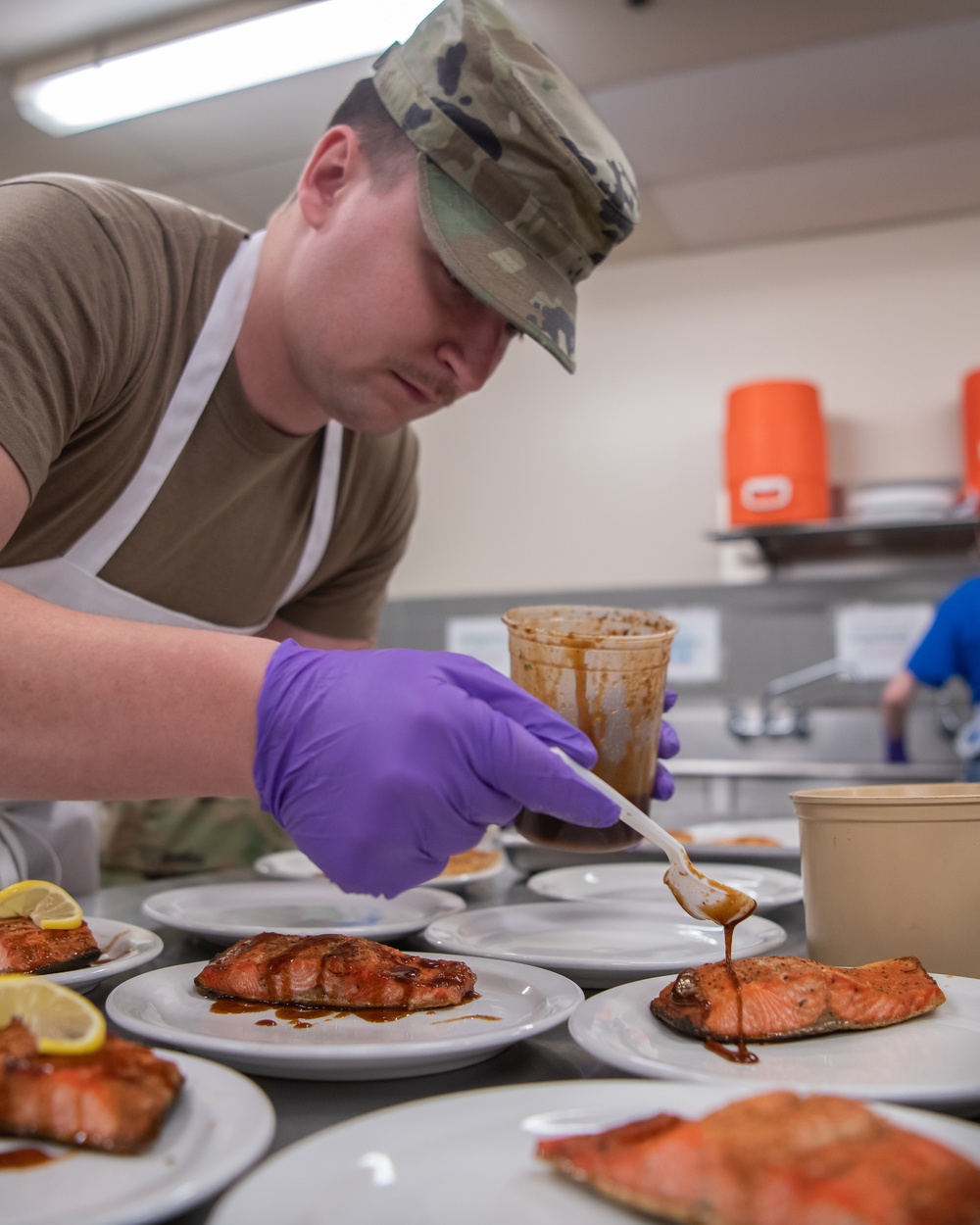 138th Fighter Wing services prepares a meal for the Air National Guard command chief