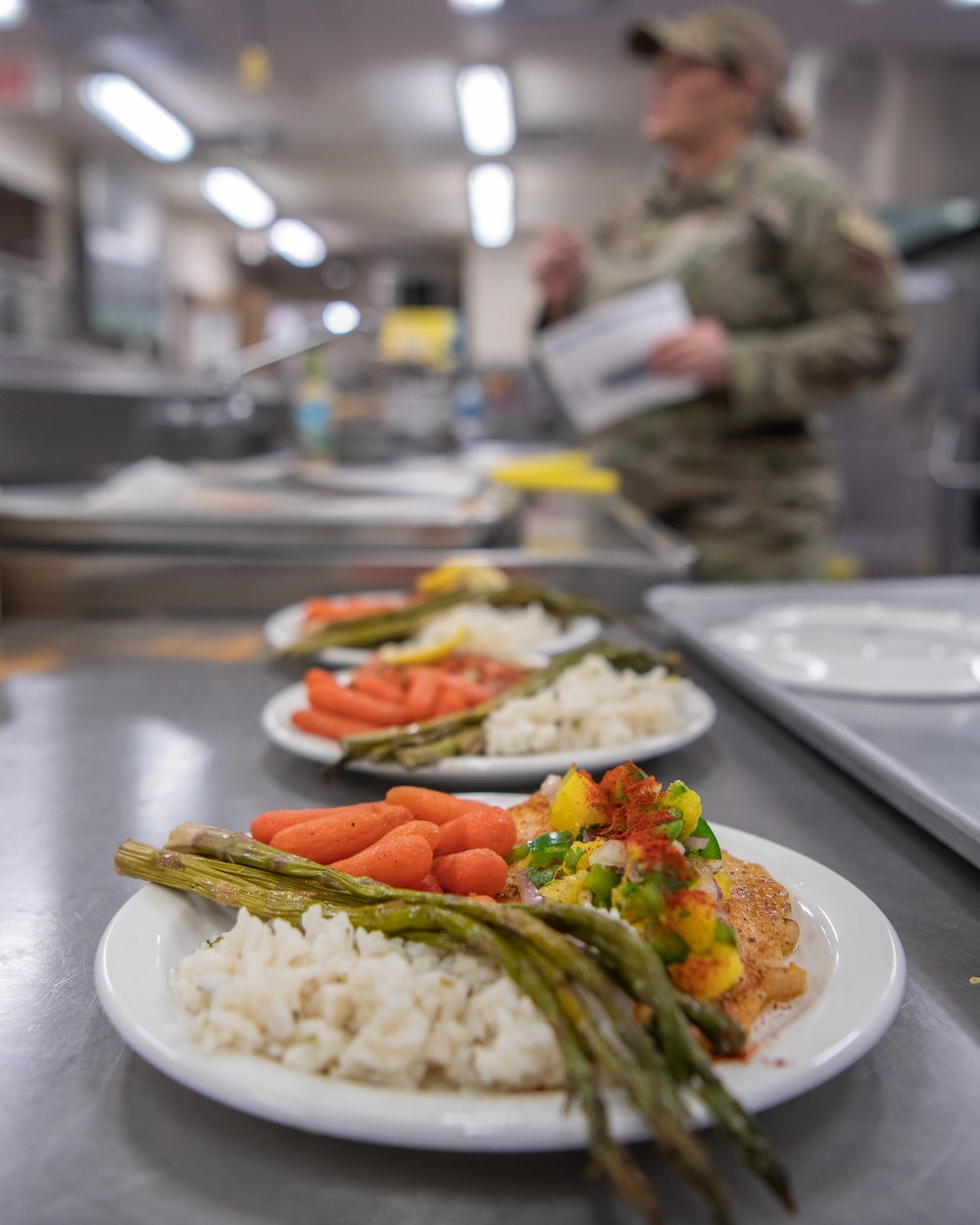 138th Fighter Wing services prepares a meal for the Air National Guard command chief