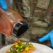 138th Fighter Wing services prepares a meal for the Air National Guard command chief