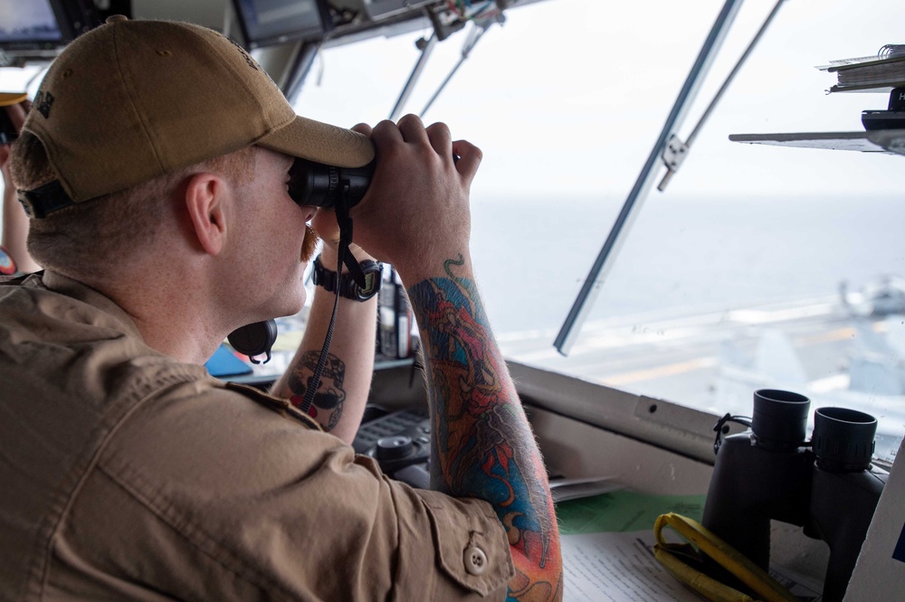 USS Ronald Reagan (CVN 76) Sailors stand watch in the pilot house