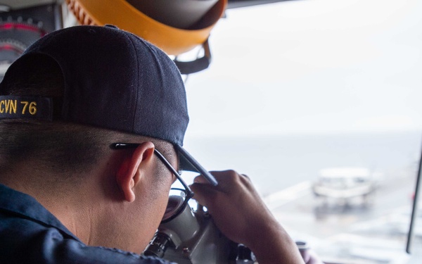 USS Ronald Reagan (CVN 76) Sailors stand watch in the pilot house