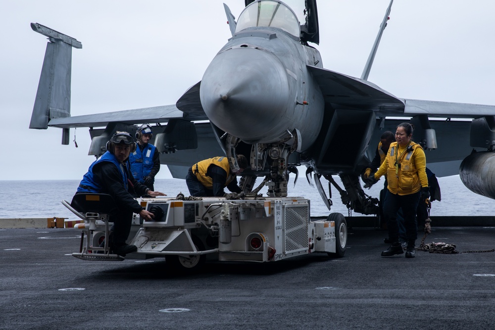 Sailors transport an aircraft aboard Abraham Lincoln