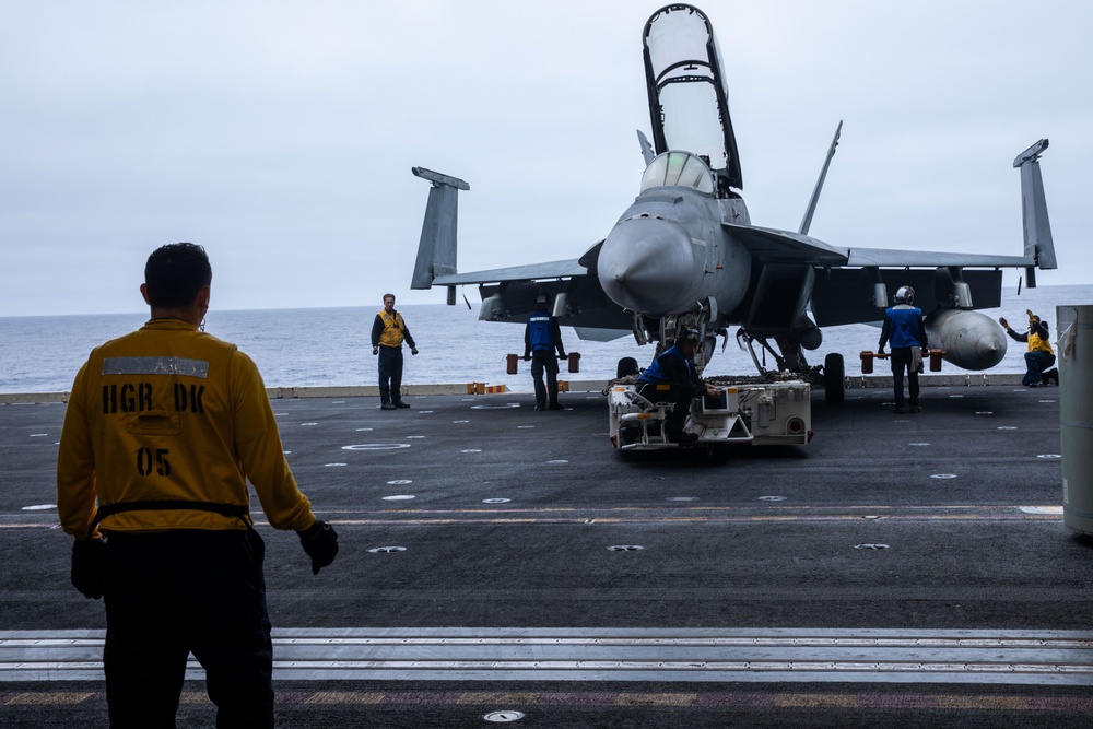 Sailors transport an aircraft aboard Abraham Lincoln