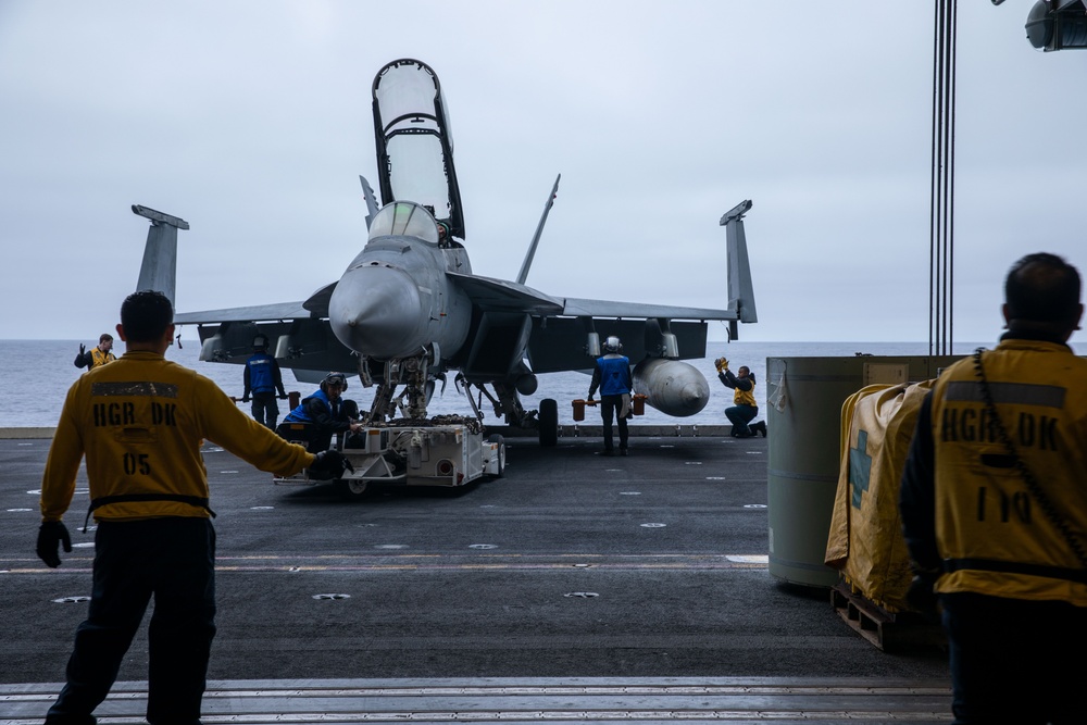 Sailors transport an aircraft aboard Abraham Lincoln