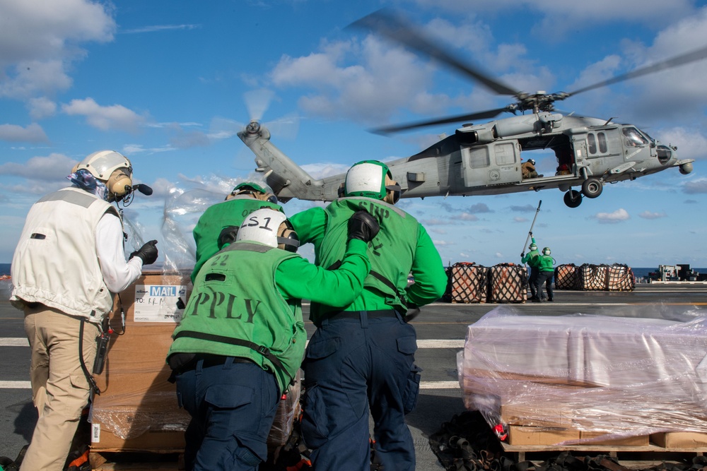 USS Ronald Reagan (CVN 76) conducts a vertical replenishment-at-sea with USNS John Ericsson (T-AO 194)