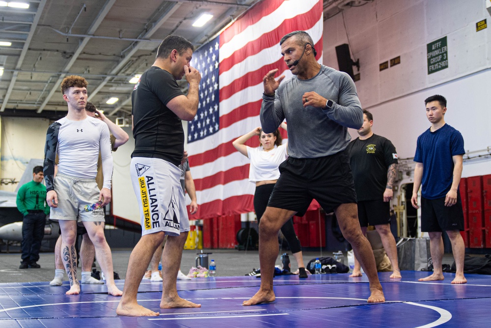 USS Ronald Reagan (CVN 76) Sailors participate  in a fitness session with Vitor Belfort