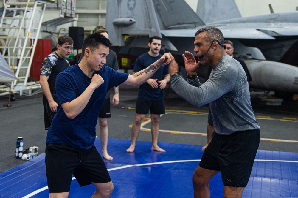 USS Ronald Reagan (CVN 76) Sailors participate  in a fitness session with Vitor Belfort