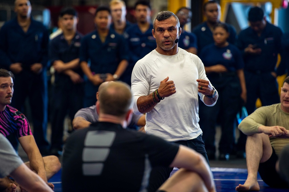 USS Ronald Reagan (CVN 76) Sailors warm up before a fitness session with Vitor Belfort
