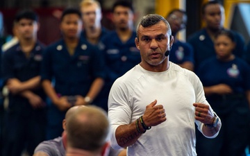 USS Ronald Reagan (CVN 76) Sailors warm up before a fitness session with Vitor Belfort