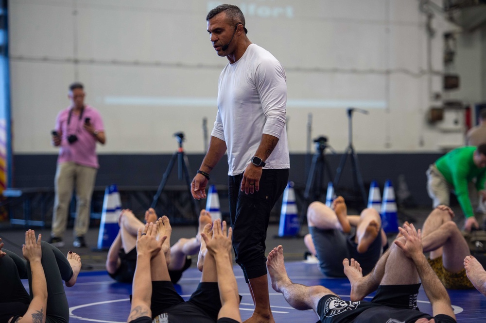 USS Ronald Reagan (CVN 76) Sailors warm up before a fitness session with Vitor Belfort