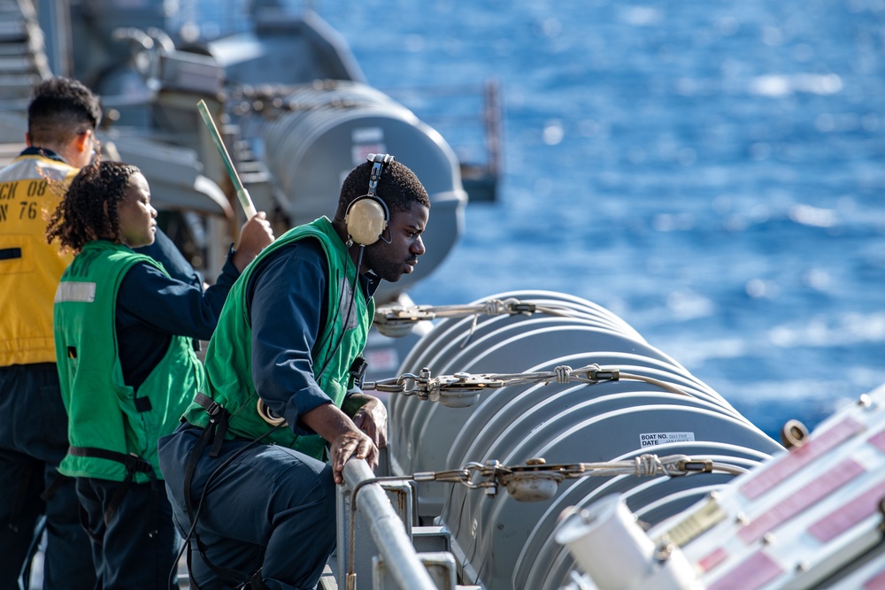 USS Ronald Reagan (CVN 76) conducts fueling-at-sea with Arleigh Burke-class  guided-missile destroyer USS Ralph Johnson (DDG 114)