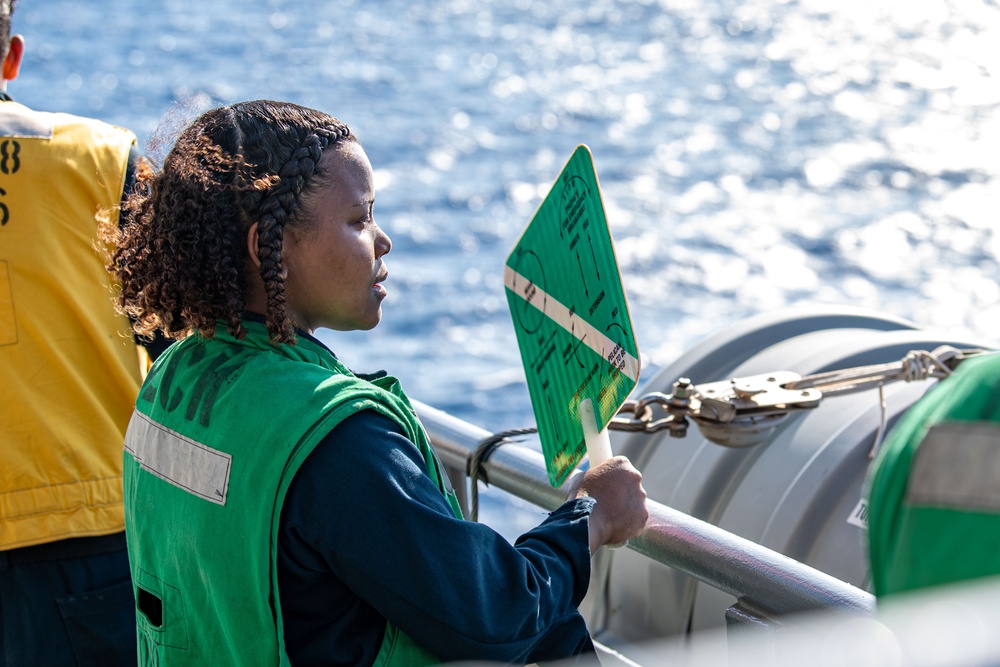 USS Ronald Reagan (CVN 76) conducts fueling-at-sea with Arleigh Burke-class  guided-missile destroyer USS Ralph Johnson (DDG 114)