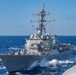 USS Ronald Reagan (CVN 76) conducts fueling-at-sea with Arleigh Burke-class  guided-missile destroyer USS Ralph Johnson (DDG 114)