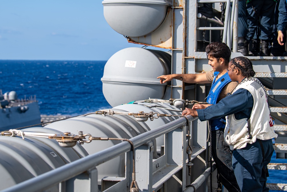 USS Ronald Reagan (CVN 76) conducts fueling-at-sea with Arleigh Burke-class  guided-missile destroyer USS Ralph Johnson (DDG 114)
