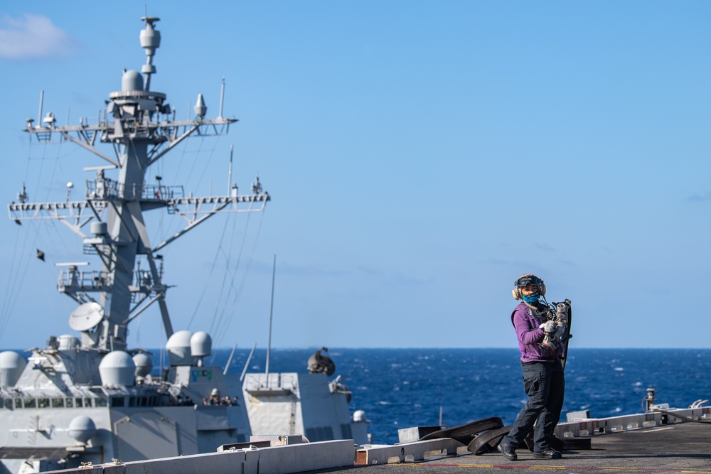 USS Ronald Reagan (CVN 76) conducts fueling-at-sea with Arleigh Burke-class  guided-missile destroyer USS Ralph Johnson (DDG 114)