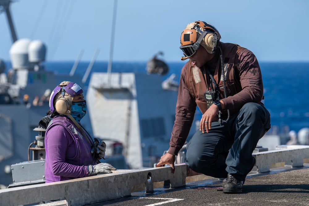 USS Ronald Reagan (CVN 76) conducts fueling-at-sea with Arleigh Burke-class  guided-missile destroyer USS Ralph Johnson (DDG 114)