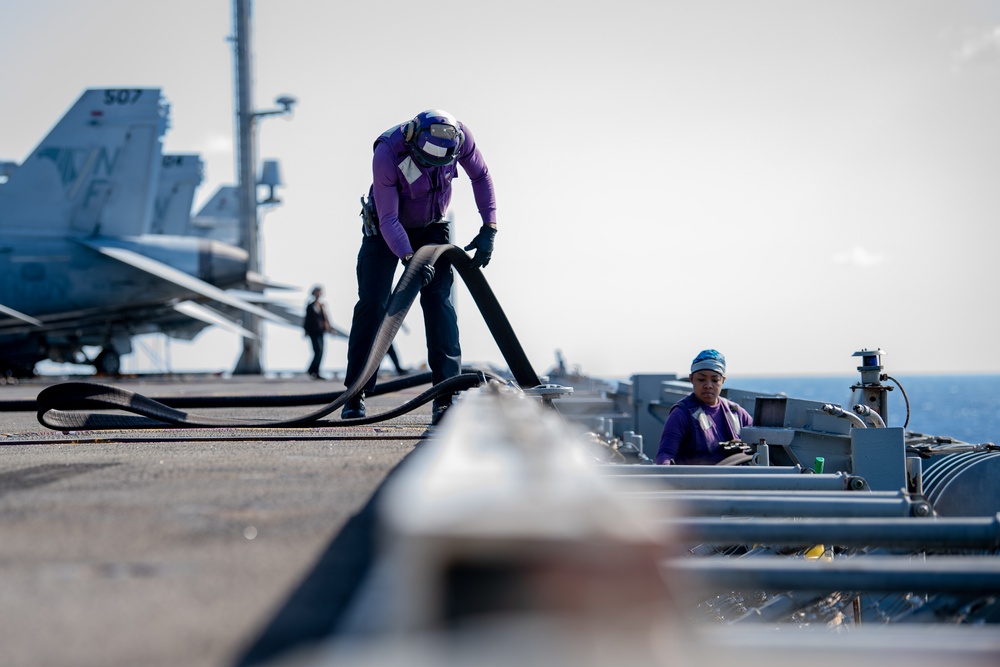 USS Ronald Reagan (CVN 76) conducts fueling-at-sea with Arleigh Burke-class  guided-missile destroyer USS Ralph Johnson (DDG 114)