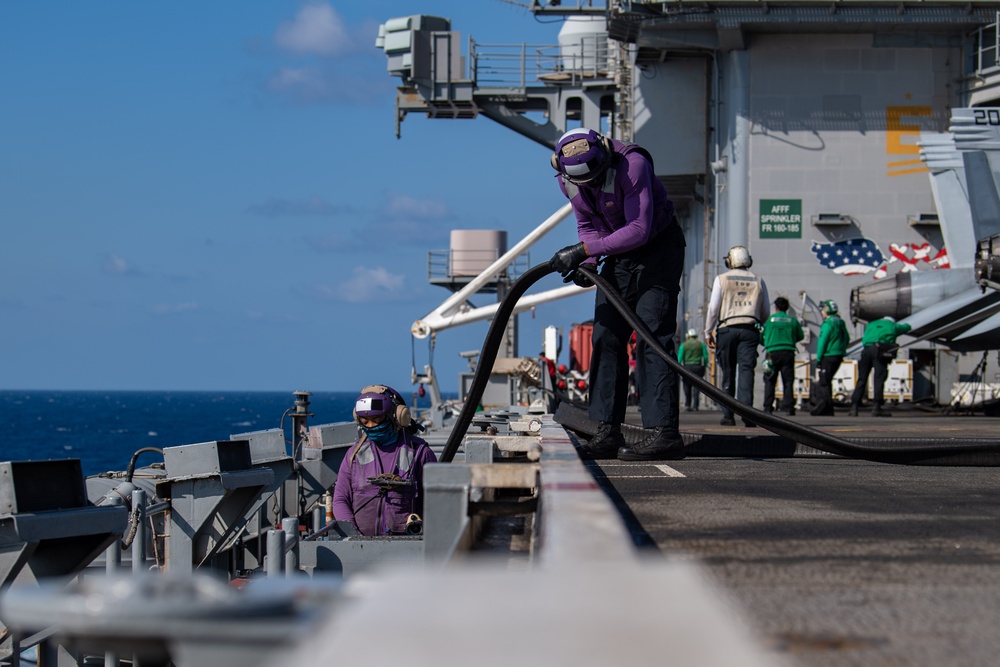USS Ronald Reagan (CVN 76) conducts fueling-at-sea with Arleigh Burke-class  guided-missile destroyer USS Ralph Johnson (DDG 114)