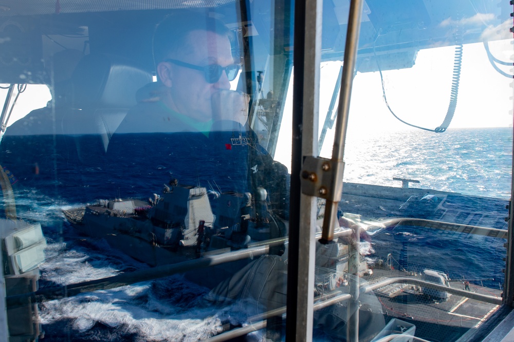 USS Ronald Reagan (CVN 76) conducts fueling-at-sea with  USS Ralph Johnson (DDG 114)