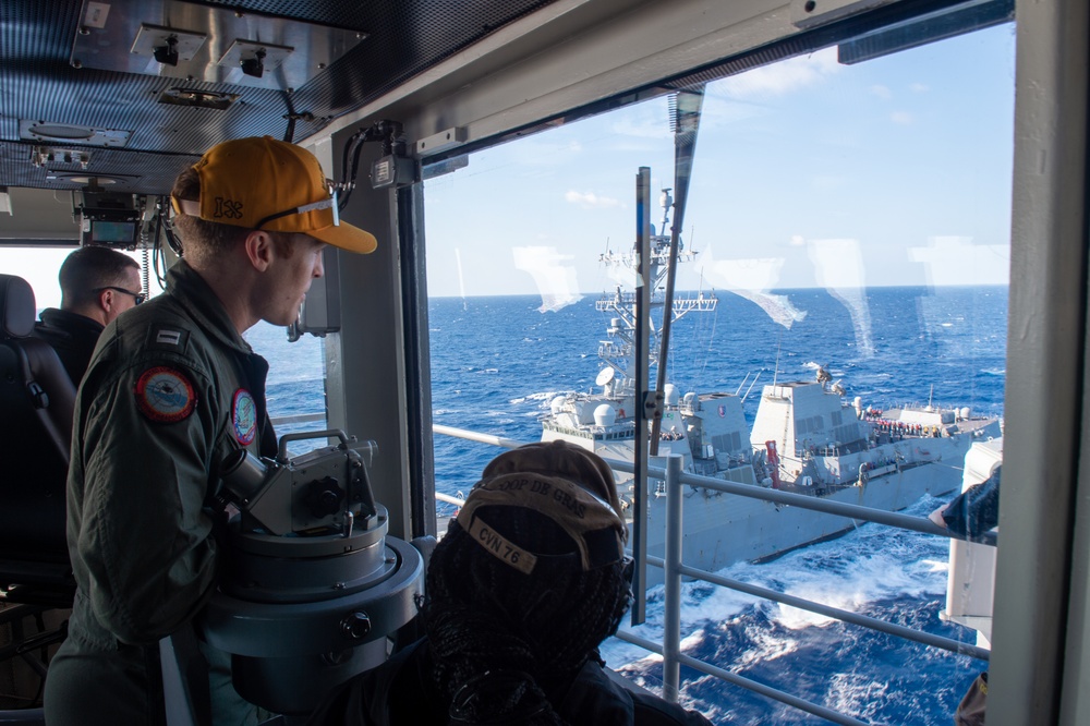 USS Ronald Reagan (CVN 76) conducts fueling-at-sea with  USS Ralph Johnson (DDG 114)