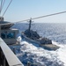 USS Ronald Reagan (CVN 76) conducts fueling-at-sea with  USS Ralph Johnson (DDG 114)