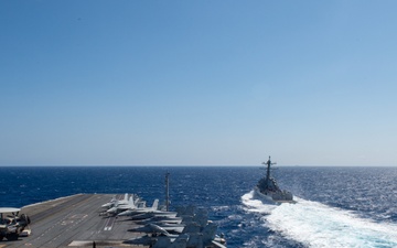 USS Ronald Reagan (CVN 76) conducts fueling-at-sea with  USS Ralph Johnson (DDG 114)