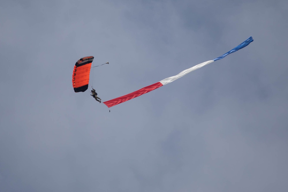 Service members perform a free-fall jump near Amfreville, France