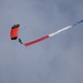 Service members perform a free-fall jump near Amfreville, France