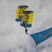 Service members and civilians perform a freefall jump near Amfreville, France