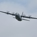 Service members and civilians perform a freefall jump near Amfreville, France