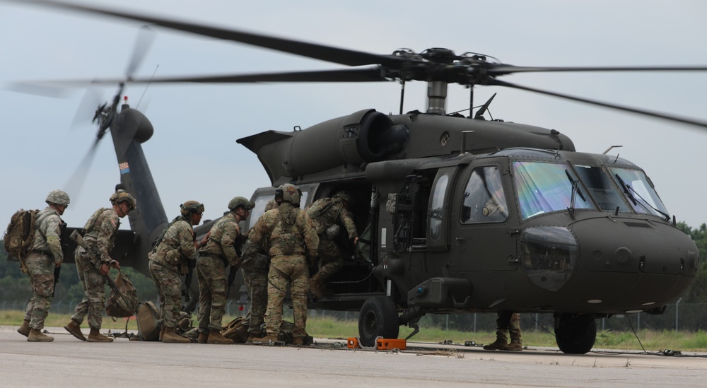 U.S. Army Soldiers of Alpha Company, 2-285th Assault Helicopter Battalion and Bravo Company 2-285th Aviation Regiment, assist in loading a Black Hawk helicopter