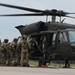 U.S. Army Soldiers of Alpha Company, 2-285th Assault Helicopter Battalion and Bravo Company 2-285th Aviation Regiment, assist in loading a Black Hawk helicopter